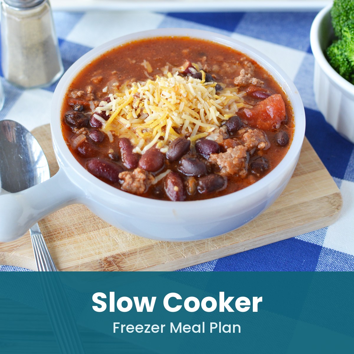 Slow Cooker freezer meal plan: bowl of beef and bean chili topped with shredded cheese