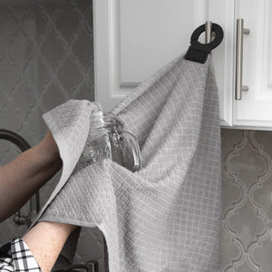 gray hook and hang towel, hung from kitchen cabinet door pull